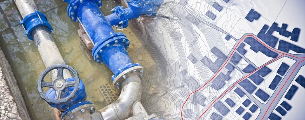 Blue water main pipework in a trench, blended with a site plan showing a red boundary line